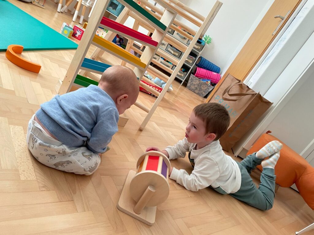 Two kids play with montessori toy